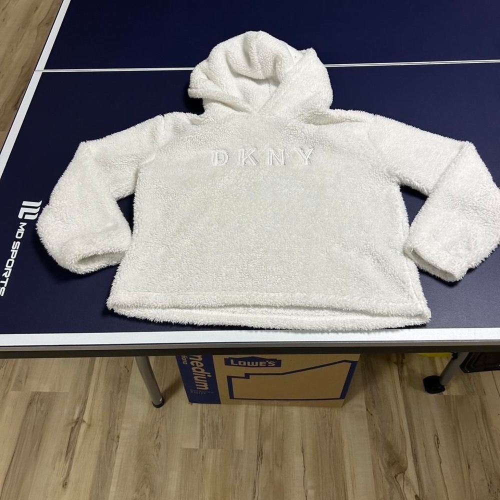 DKNY white sherpa hoodie. There is a spot between the N and Y. Size XS